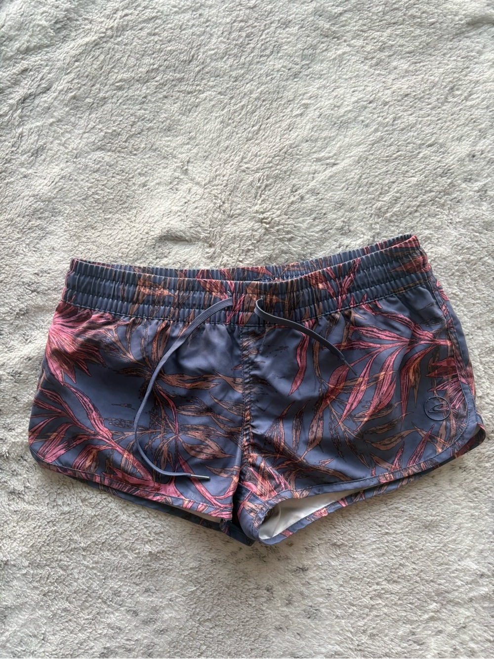 O'Neill Pink Leaf Print Athletic Shorts on Blue